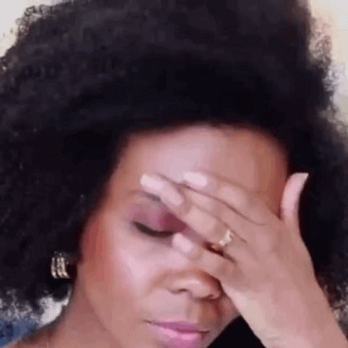 an afro girl with large hair covering her face