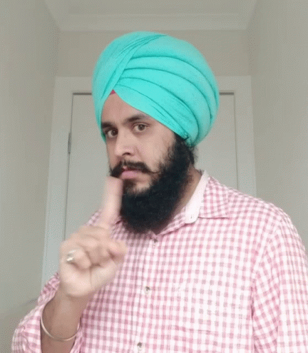 man in turban holding up his finger