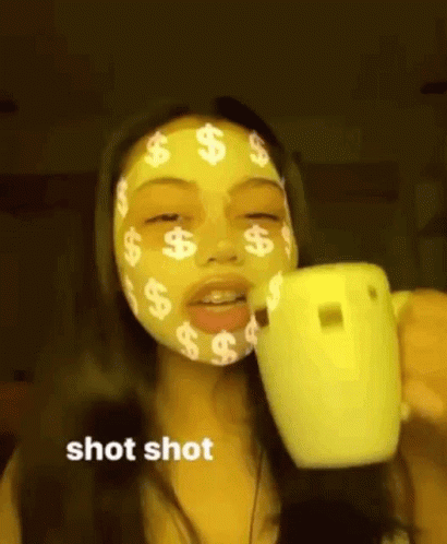a girl with dollars covering her face and holding coffee cup
