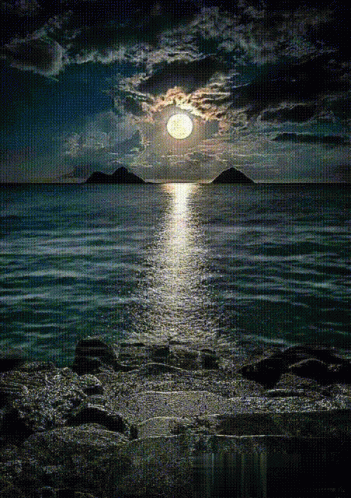 moon shines in front of the moon over the water
