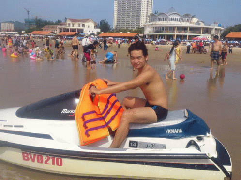 a man sitting on a white and brown jet ski in the water