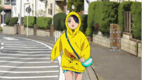 a girl with a hoodie walking down the street