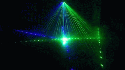 a green and red laser beam in a dark room