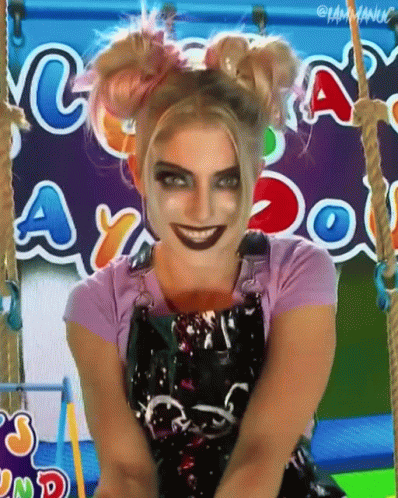a child's face with blue makeup wearing a clown make up