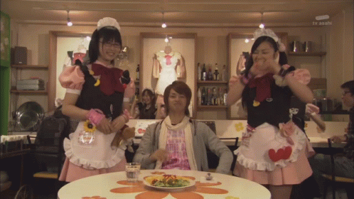 the three girls are standing up wearing aprons