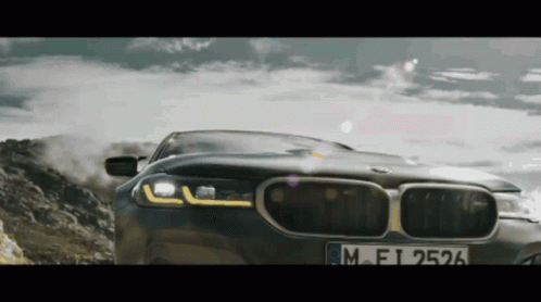 a close up of a car driving down a mountain