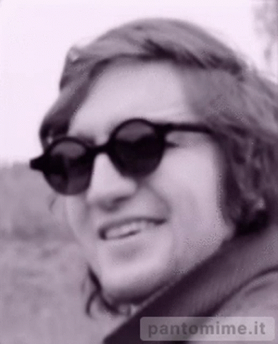 a black and white image of a man wearing sunglasses