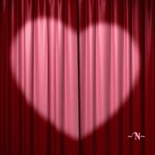 there is a curtain in front of a heart symbol