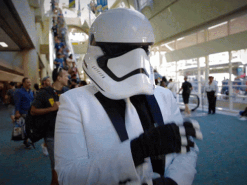 a person wearing a star wars helmet and holding a camera