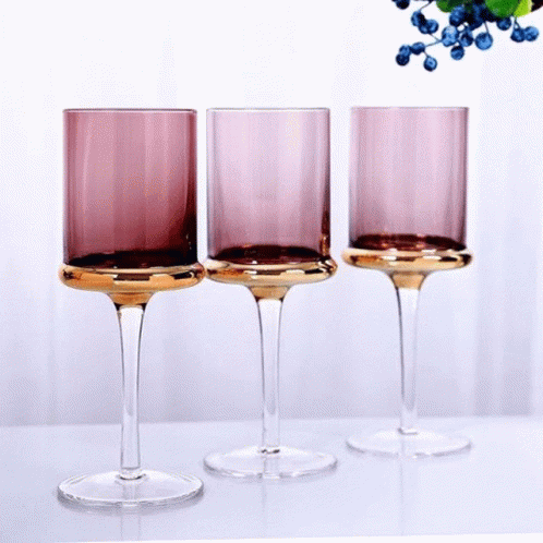 three blue wine glasses set next to each other
