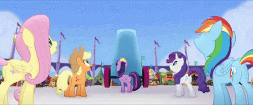 three colorfully painted ponys in front of tall buildings