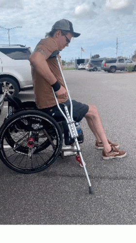 a man is in a wheelchair with a cane