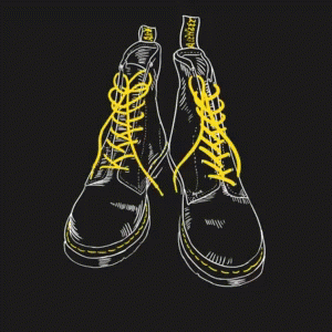 a pair of shoes with green laces sit on top of a black background