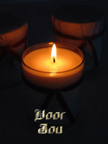 a lit candle that reads, god is