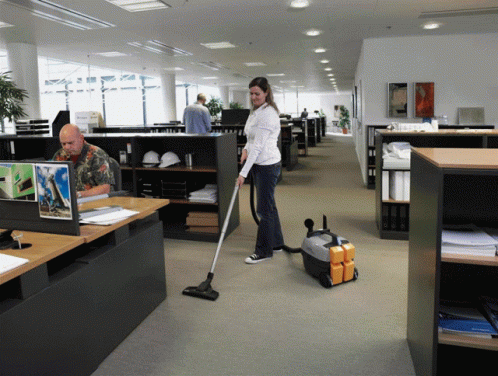 the woman is cleaning the floor in the office