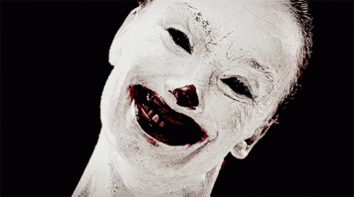 a clown laughs with his teeth covered in paint