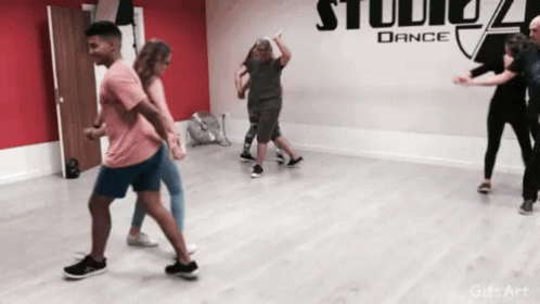 people are doing different moves in a dance studio