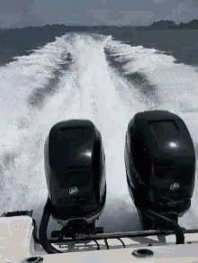two motorboats are traveling behind each other in the water