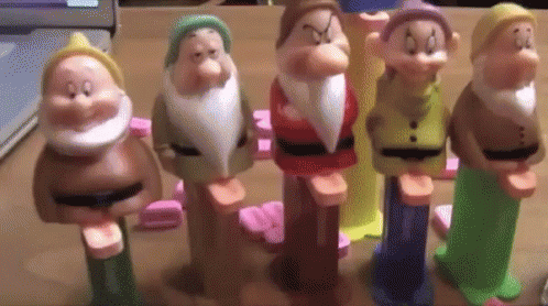 a group of toy figures of gnomes standing in the street