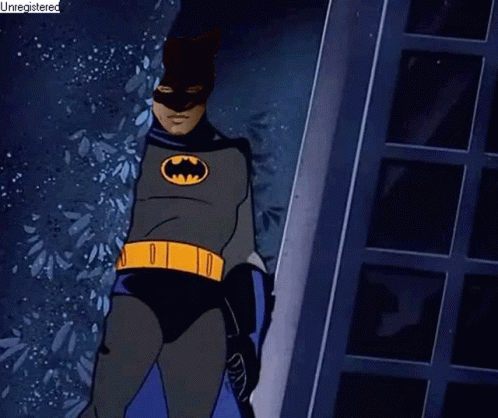 the animated batman stands in the middle of the hallway