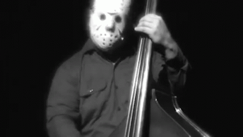 a guy with an animal's mask on playing cello