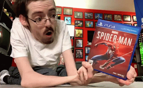 the man is laying on his bed while reading the spider - man book