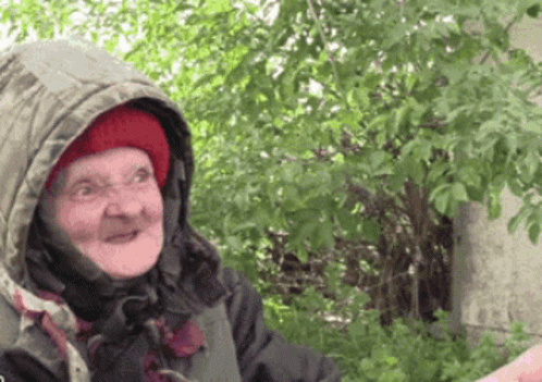 a old woman with a fake moustache has a surprised look on her face