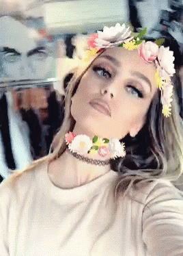 a young woman with a flower crown and choker around her neck