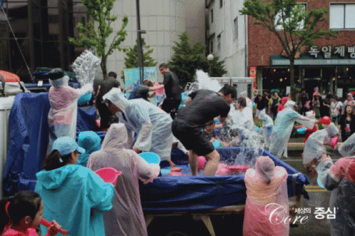 an image of people in costumes throwing and shaking in the street