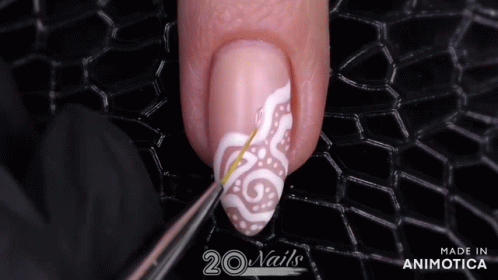 a blue and white nail with a white swirl design