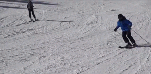 there are two people riding skis down the mountain