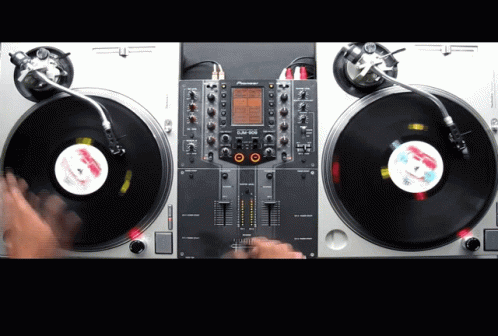 two dj controllers and a music player are holding on to the decks of an audio system