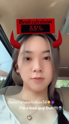 an asian woman wearing a devil horns hat