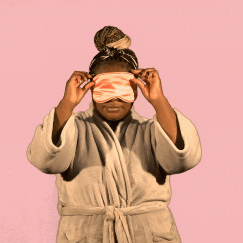 an african american woman covers her eyes with a blindfold