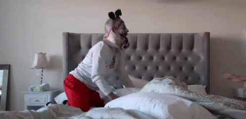 a person is in bed with the horse head on their head