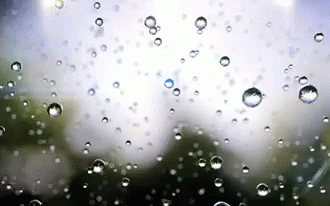 the droplets on a rainy glass look very blurry