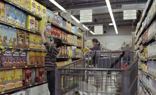 the workers are pulling a cart along the aisle
