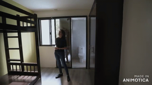a person standing on the floor in front of a bunk bed