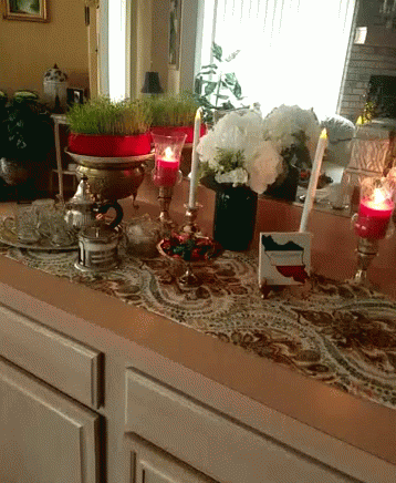 a table has various candles, and decorations on it