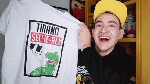 the man is displaying his own t - shirt with dinosaur designs