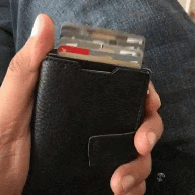 a person holding an empty wallet in their hands