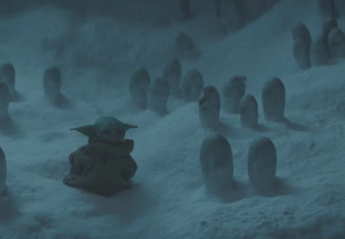 the baby yoda is sitting in the snow