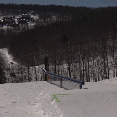 a person riding a snowboard down a ramp