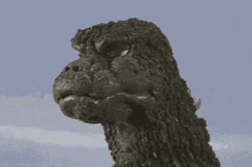 a godzilla statue is standing in front of the camera