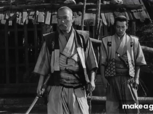 a man with an oriental outfit and two other men holding canes