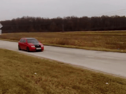 a small car going through a curve on a road