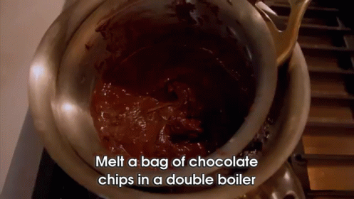 a large metal bowl filled with melted chocolate
