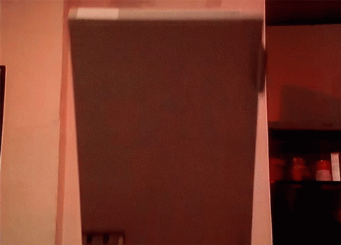an empty refrigerator in a small room with blue walls
