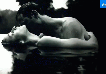 a couple is lying in a pool of water