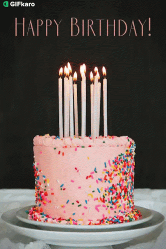 a blue birthday cake with candles is shown